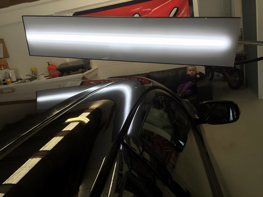 A Car With A Dent In The Roof Is Sitting In A Garage — Rapid Auto Dent In West Gosford, NSW