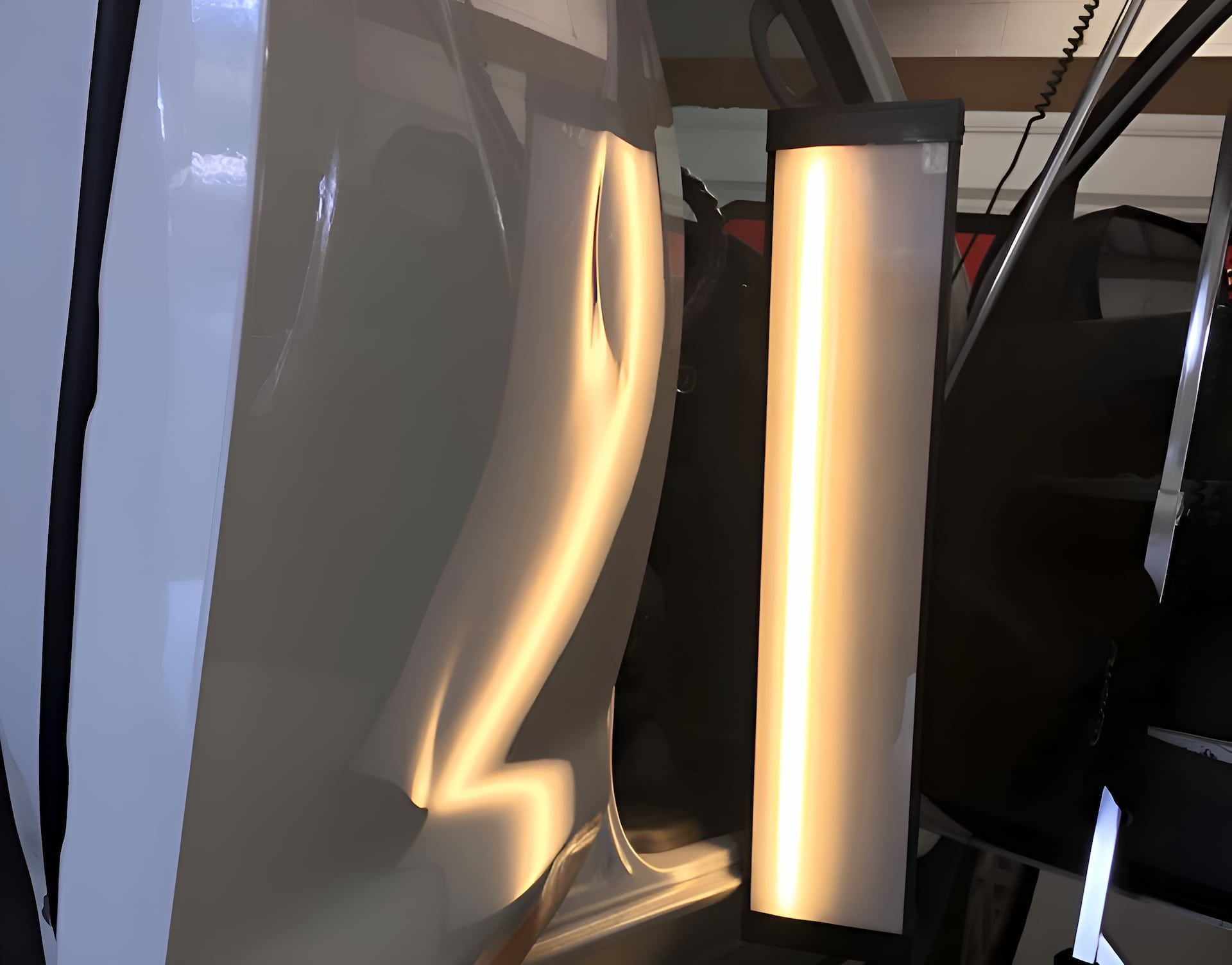 A Car With A Dent In The Door Is Being Repaired — Rapid Auto Dent In Wyong, NSW