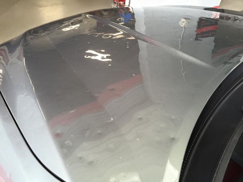 A Close Up Of The Hood Of A Car In A Garage — Rapid Auto Dent In Tuggerah, NSW