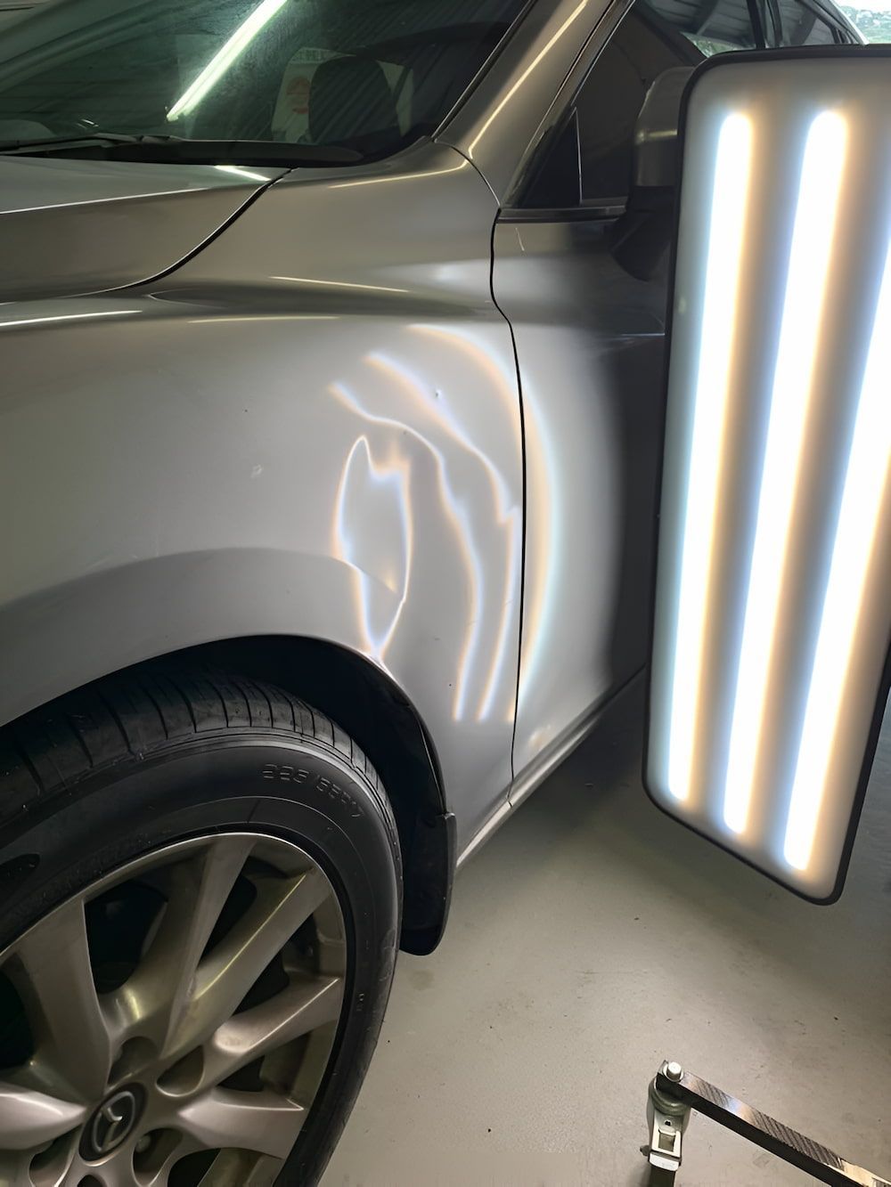 A Car With A Dent In The Fender Is Sitting Next To A Light — Rapid Auto Dent In Wyong, NSW