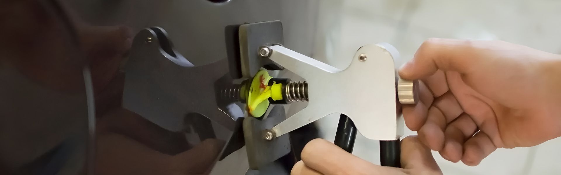 A Person Is Using A Tool To Remove A Dent From A Car  — Rapid Auto Dent In West Gosford, NSW