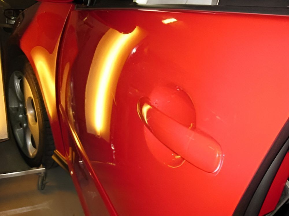 A Close Up of a Red Car's Door Handle — Rapid Auto Dent In Budgewoi, NSW