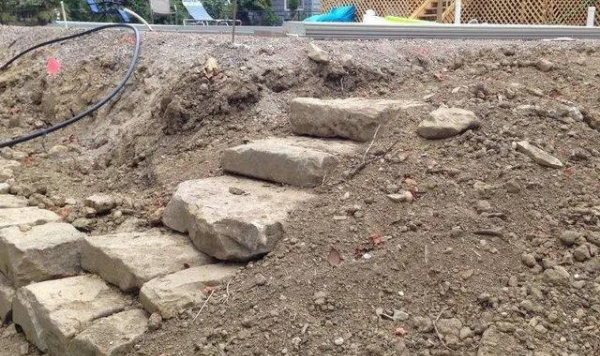 Stone steps built into a dirt slope at a construction site