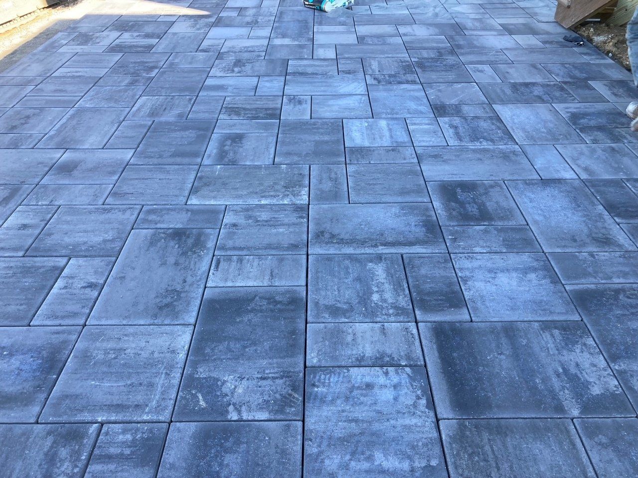 Blue-gray stone pavers laid in a patio or walkway pattern, viewed from above.