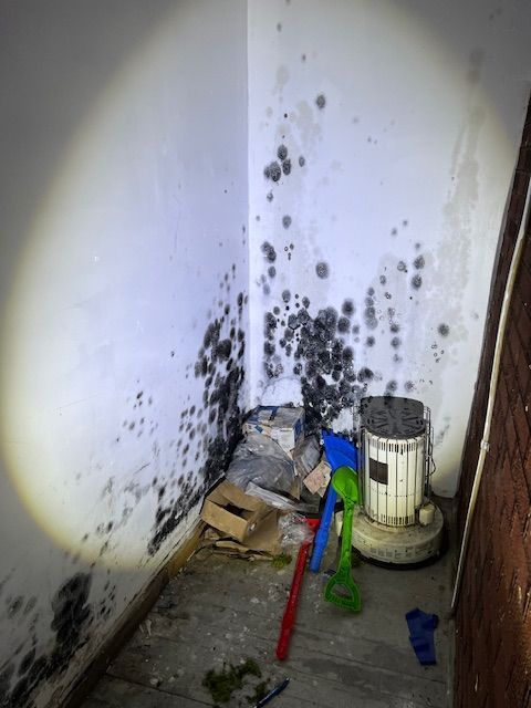 A corner of a hallway with a xman logo on it