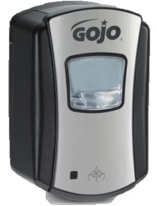 Un dispensador de jabón gojo está sobre una superficie blanca.