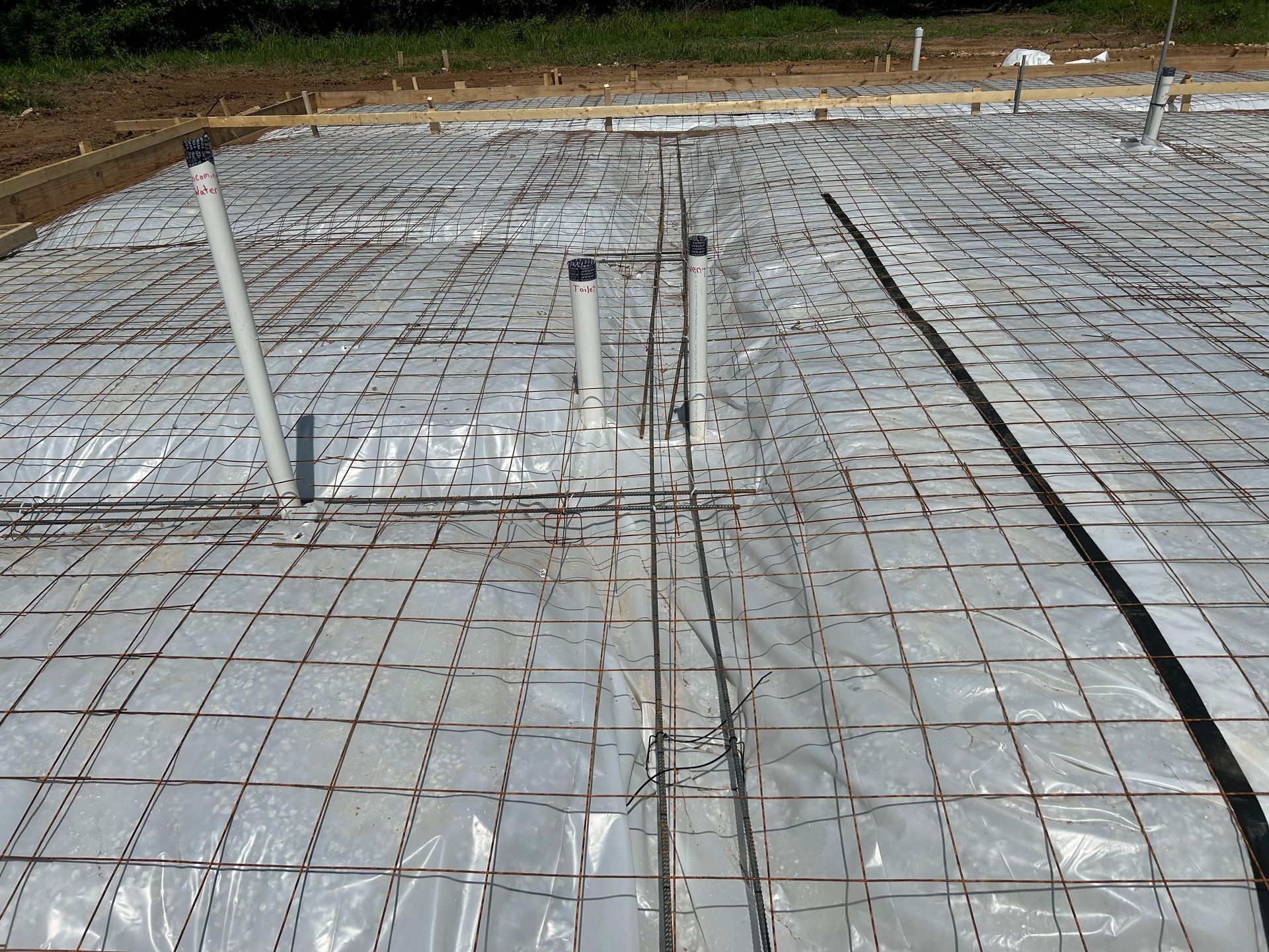 A concrete floor with a lot of pipes on it