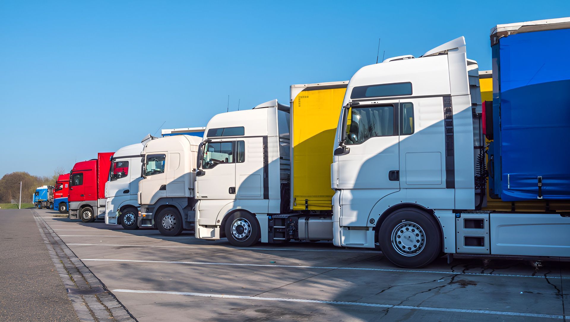 A Row Of Semi Trucks Parked In A Parking Lot — Windscreen Ambulance In Kawana, QLD