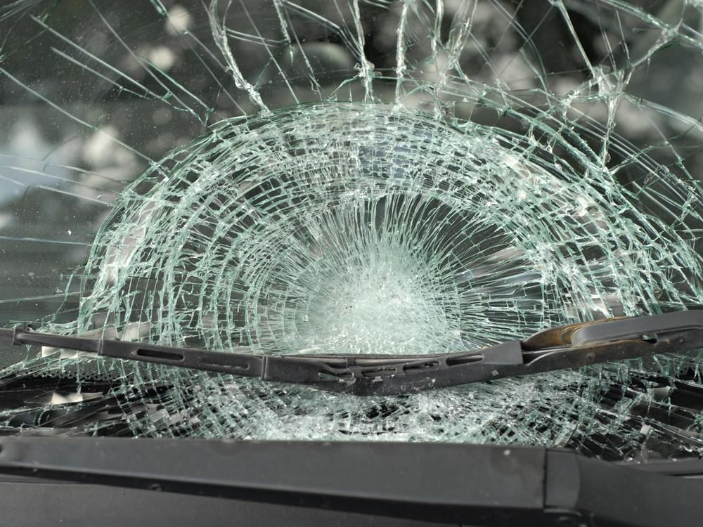 A Close Up Of A Broken Windshield With A Wiper Blade — Windscreen Ambulance In Kawana, QLD
