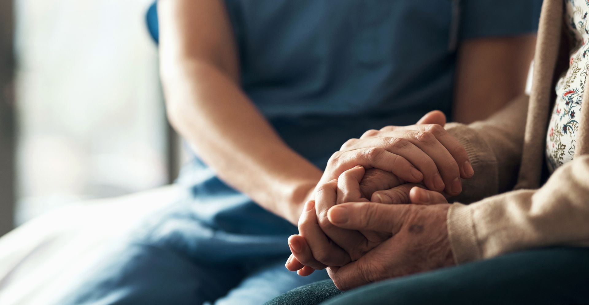 Closeup of nurse holding patient's hands, showing empathy, compassion, and support | Fort Worth, TX Closeup of nurse holding patient's hands, showing empathy, compassion, and support | Fort Worth, TX