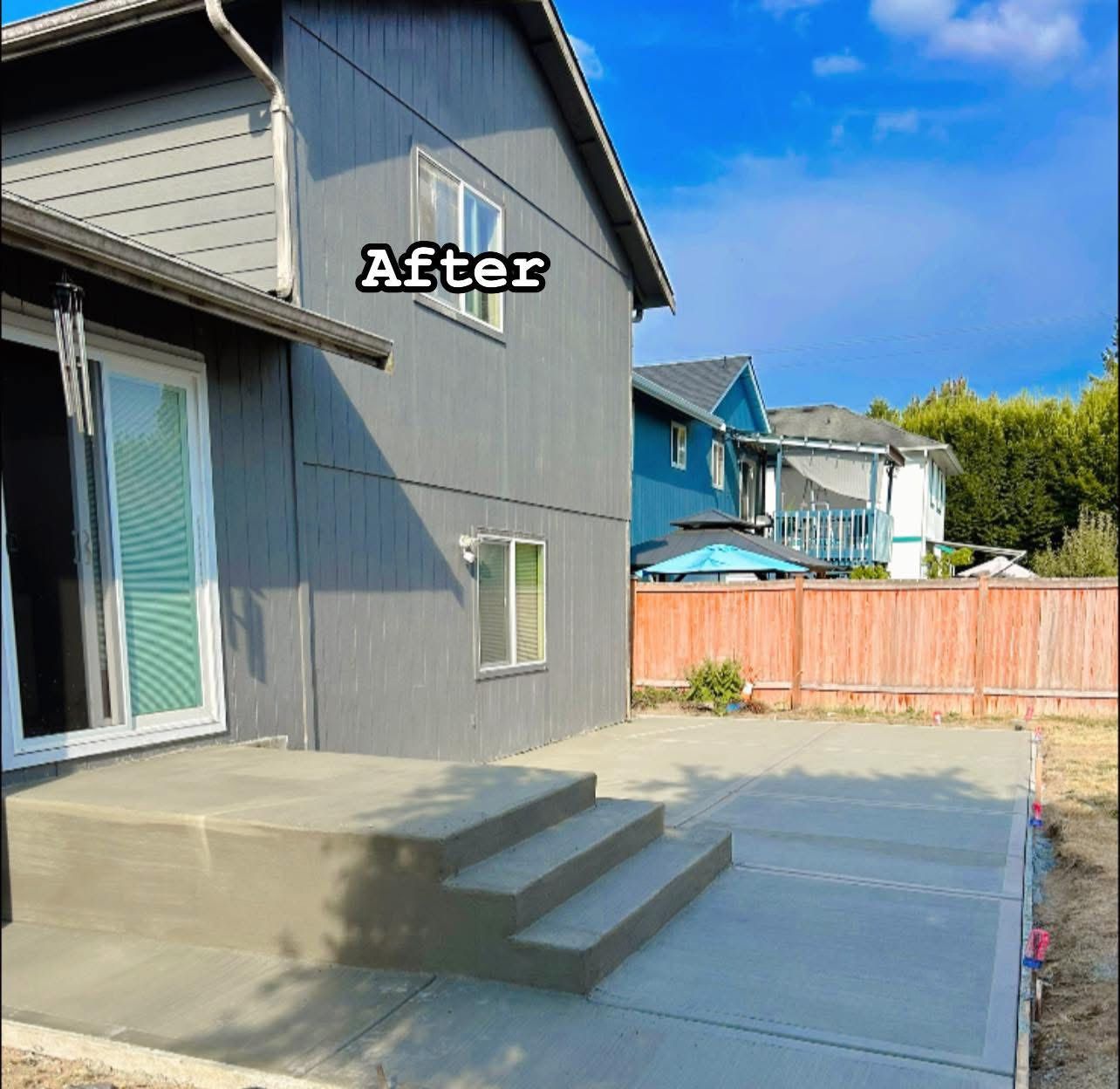 Gray house exterior with concrete patio and steps; 