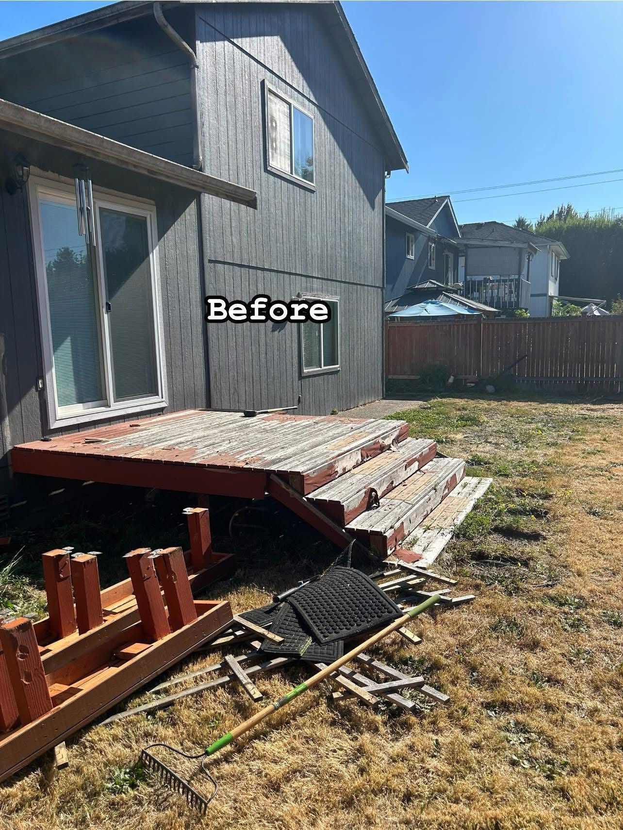 Gray house with old red deck in backyard before renovation.