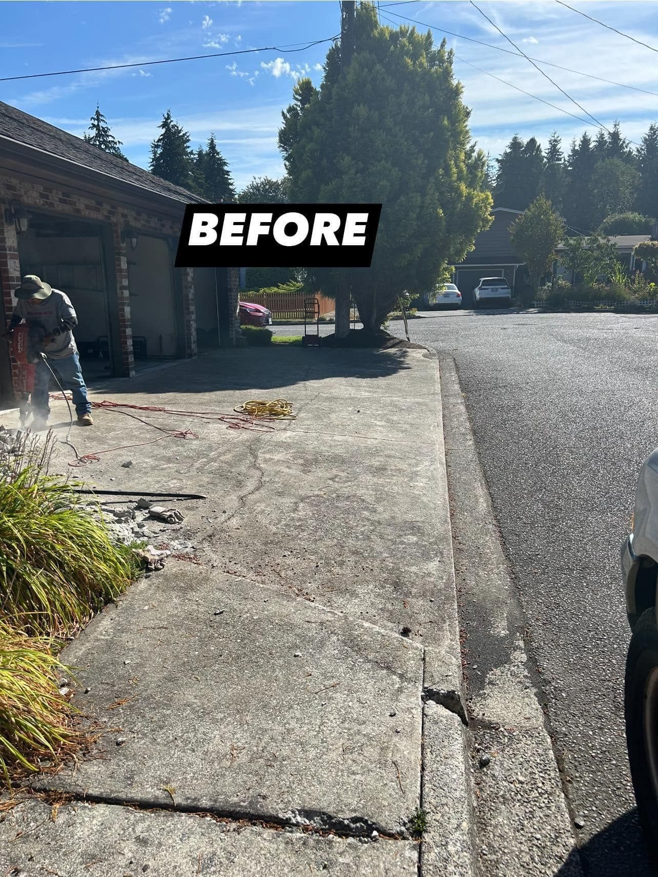 A person uses a jackhammer to remove concrete from a driveway, labeled 
