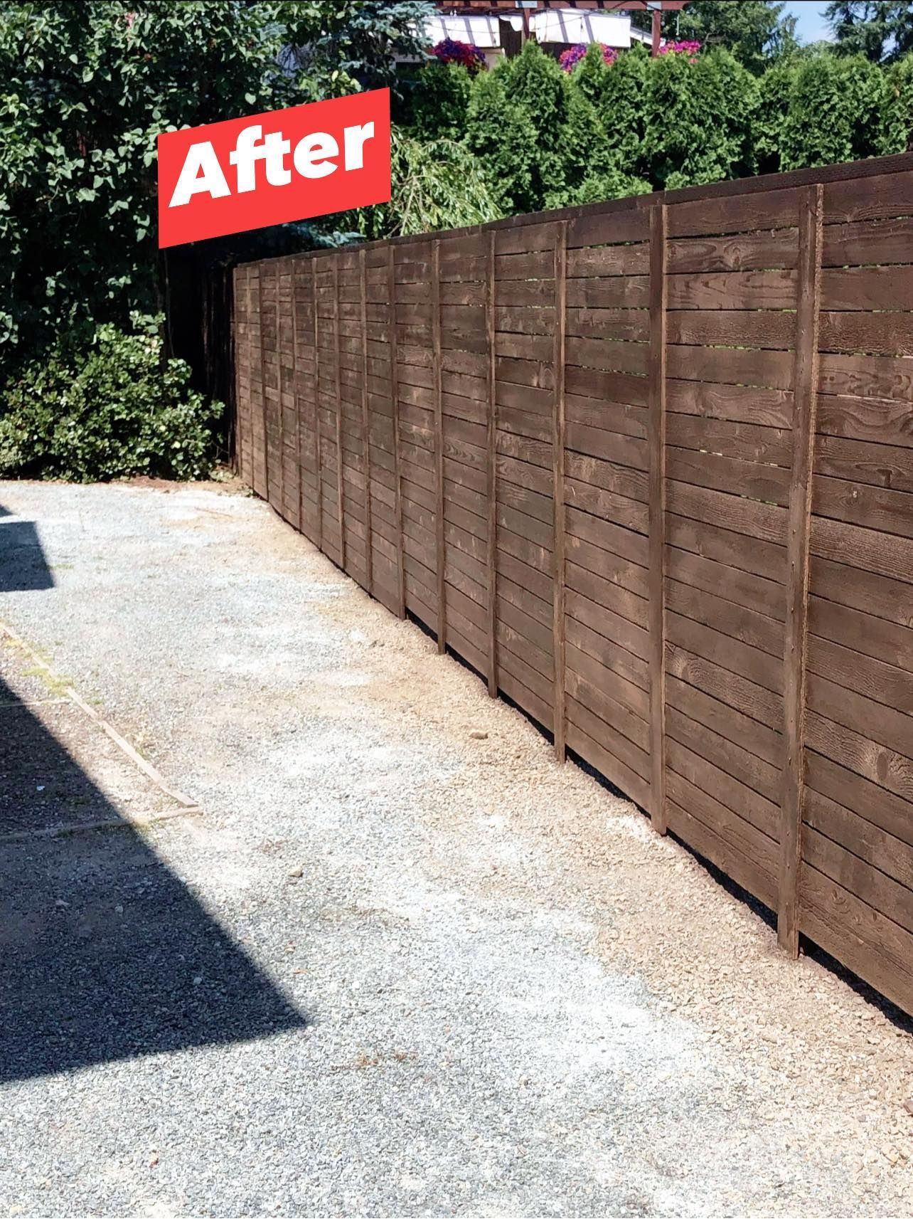 Brown wooden fence along a gravel path, 