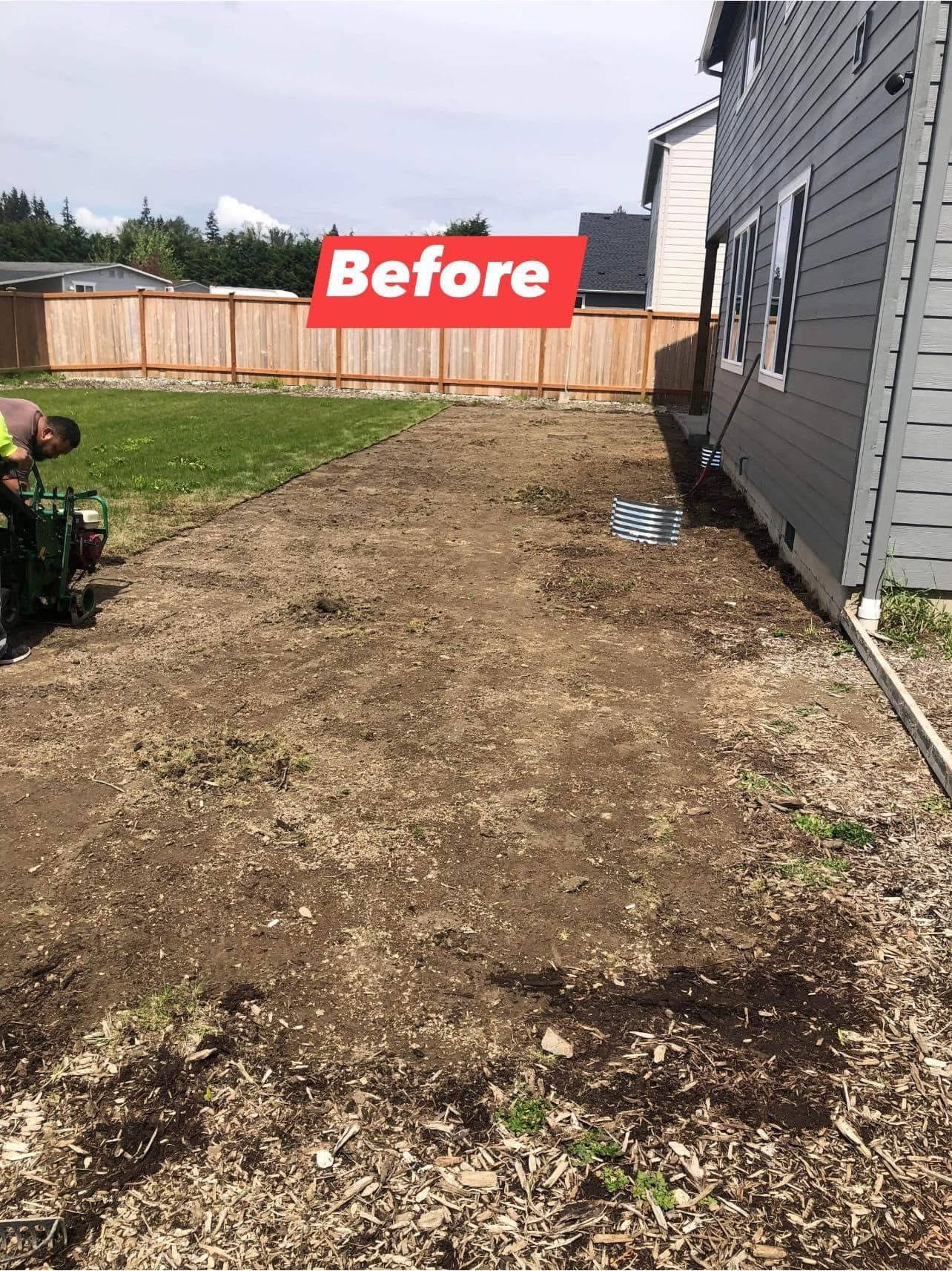 Bare dirt patch beside a gray house, labeled 