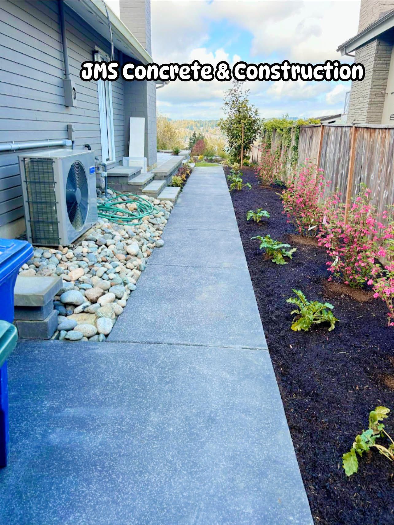 Concrete walkway with landscaping and air conditioner unit.