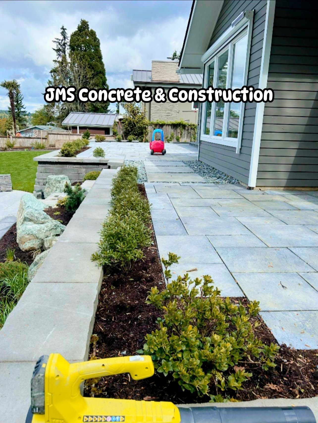 Outdoor patio and landscaping by JMS Concrete & Construction. Gray concrete walkway.
ow leaf blower.