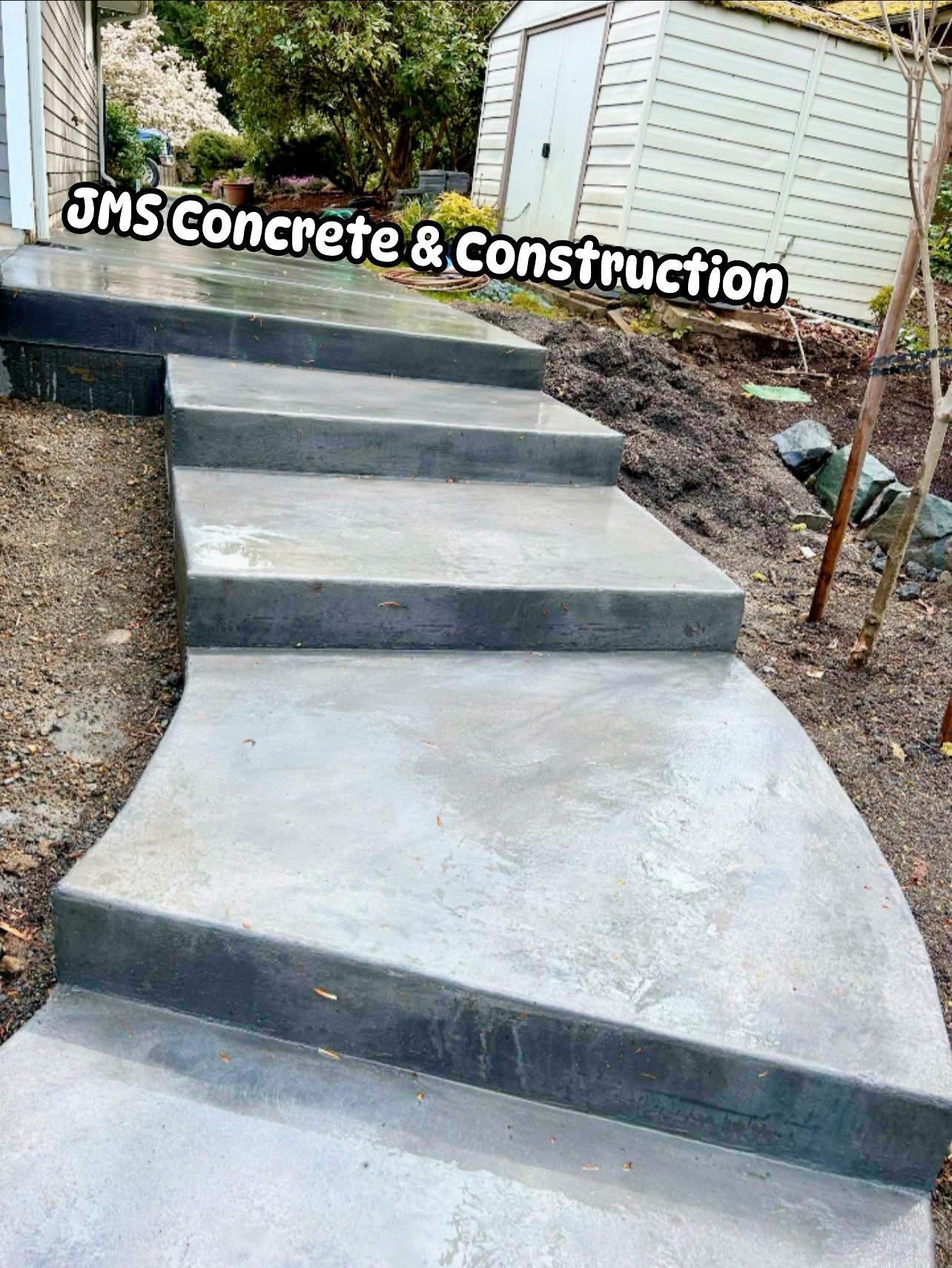 Concrete steps with curved edges leading up a small hill. JMS Concrete & Construction logo at top.