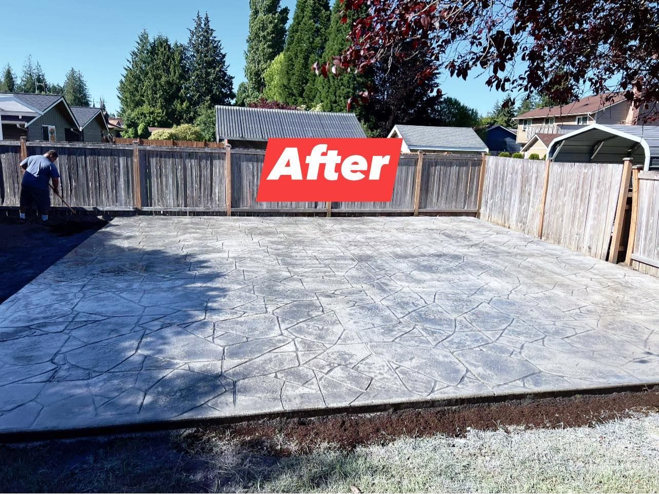 Stamped concrete patio enclosed by a wooden fence, labeled