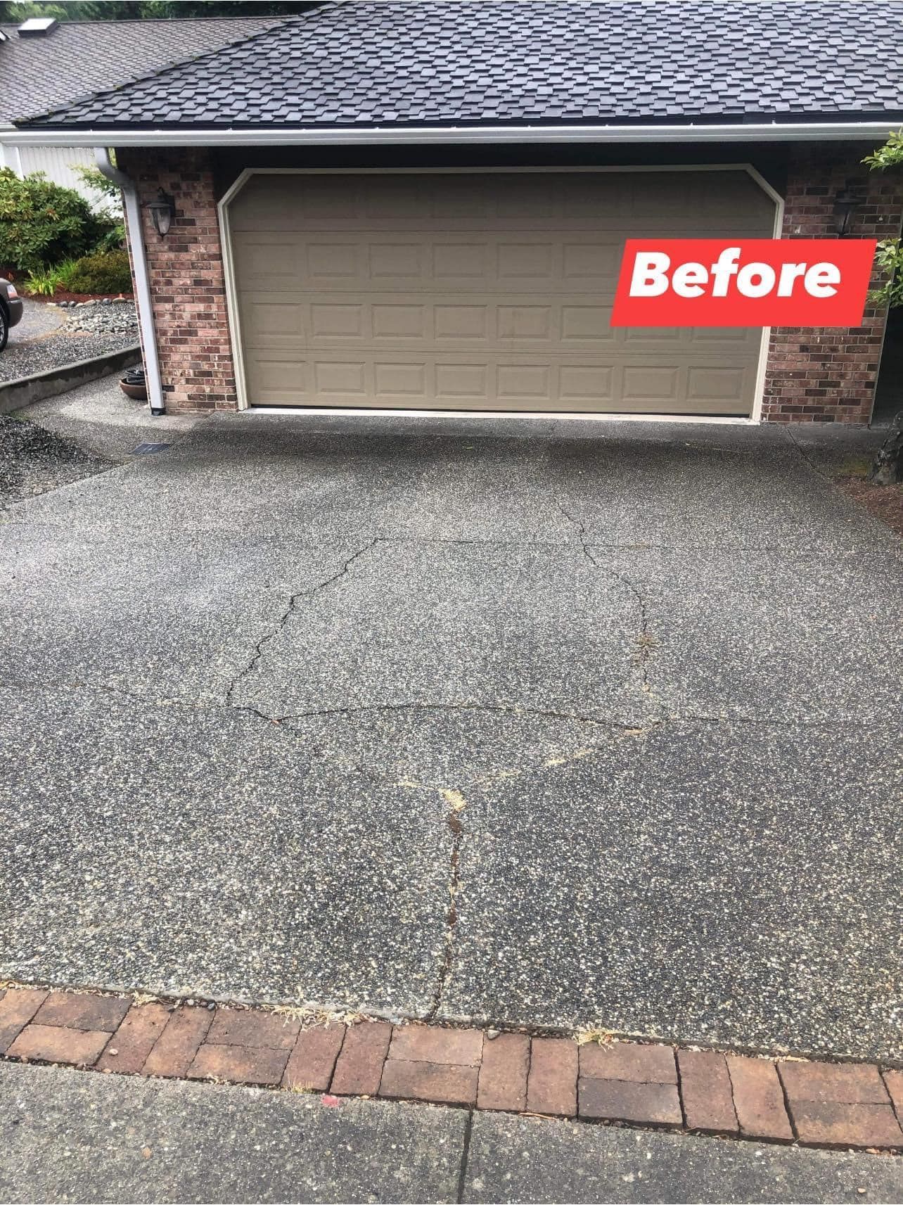 Driveway before, with garage door, brick accents, and concrete surface.