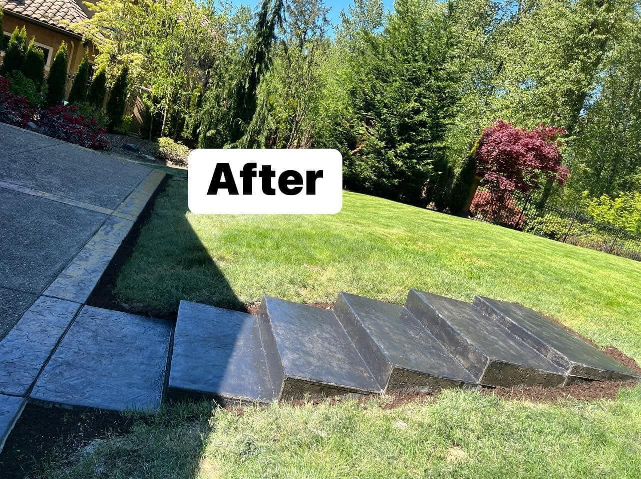 Steps leading up a grassy hill, newly installed, with a concrete walkway on the left.