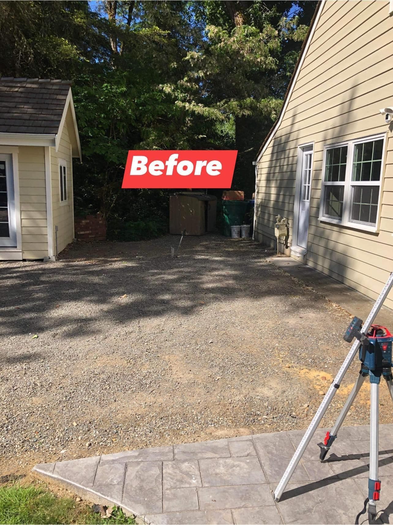 Before: Gravel yard between two buildings, with a shed on the left, a house on the right, and trees in the background.
