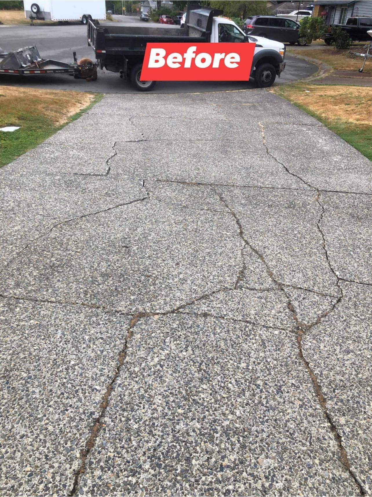 Cracked concrete driveway with a truck labeled 