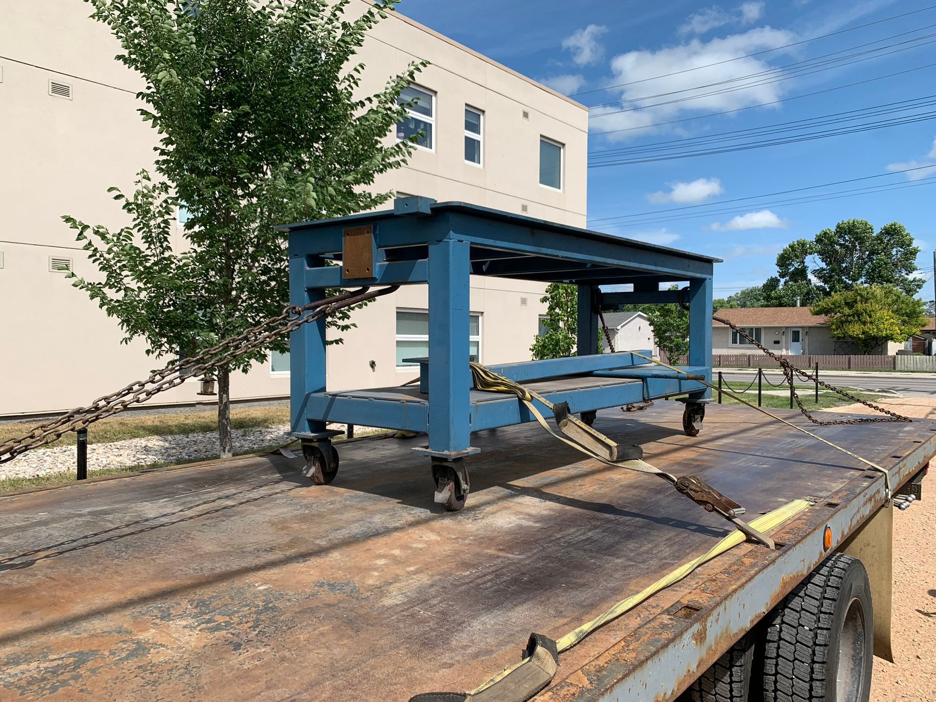 Delivering heavy metal table on flatbed tow truck across Winnipeg