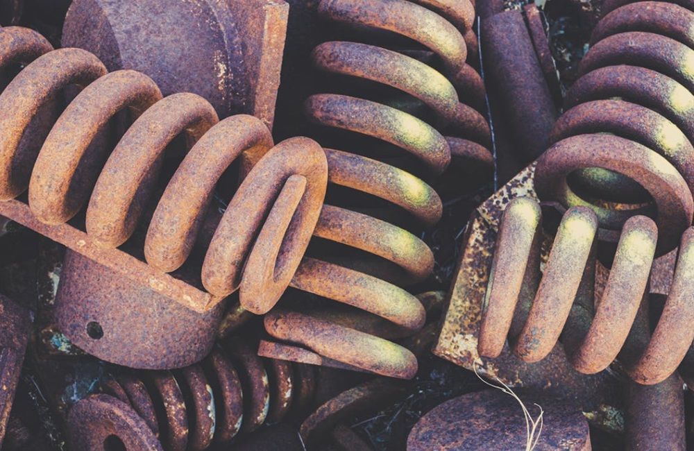 Recycle your car's scrap metal into cash! A bunch of rusty springs are sitting on top of each other.