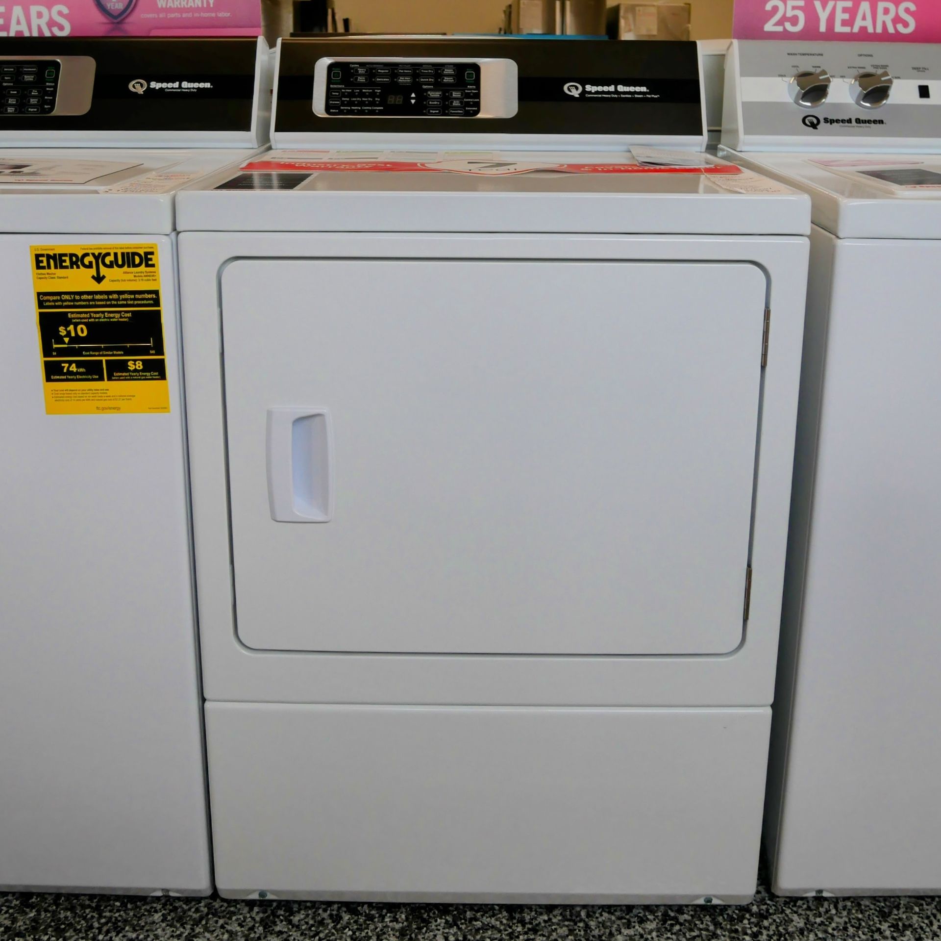 White electric clothes dryer with an EnergyGuide sticker, displayed in a store.