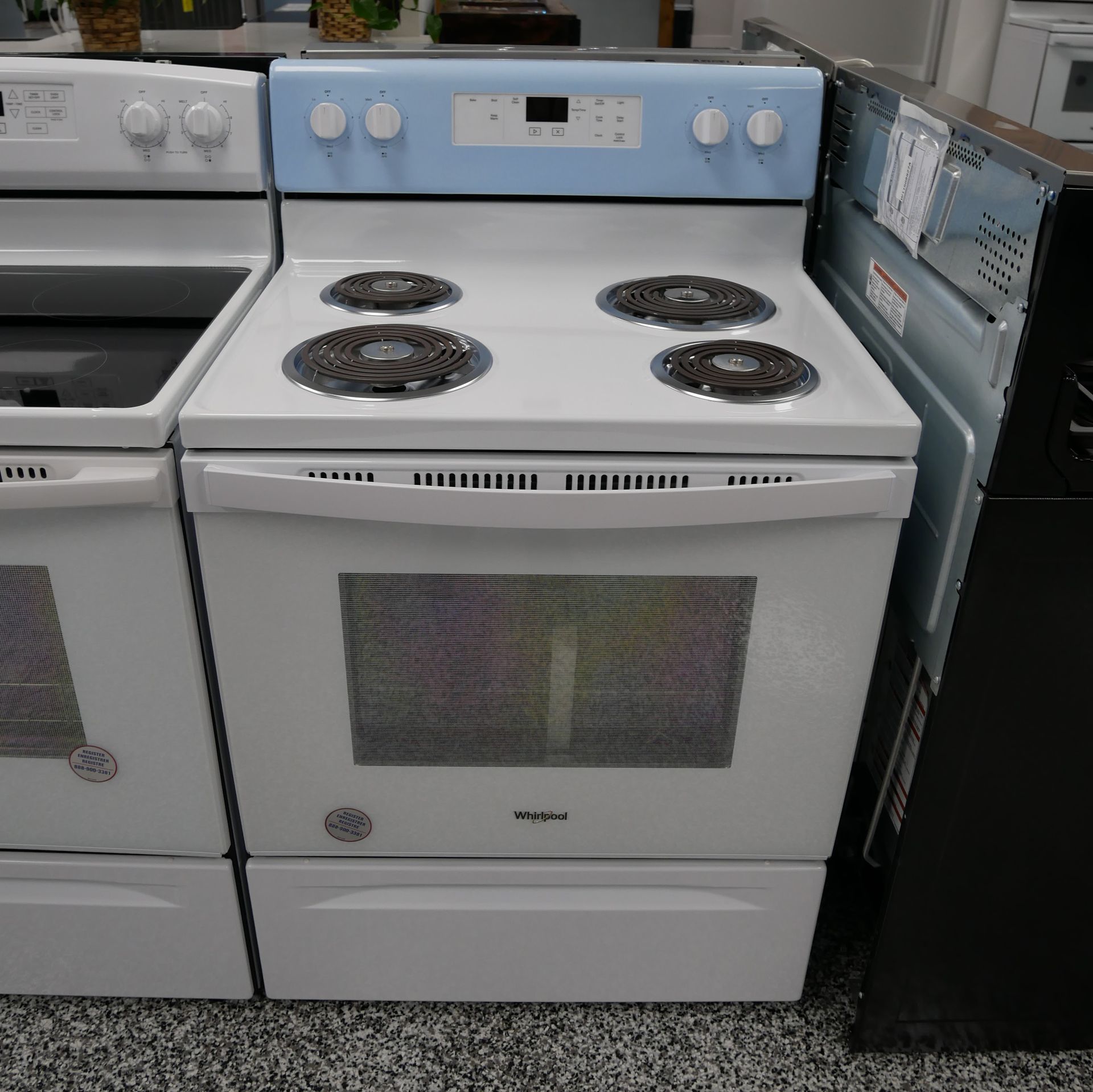 White electric range with blue control panel. Four burners, oven door with handle, and storage drawer.