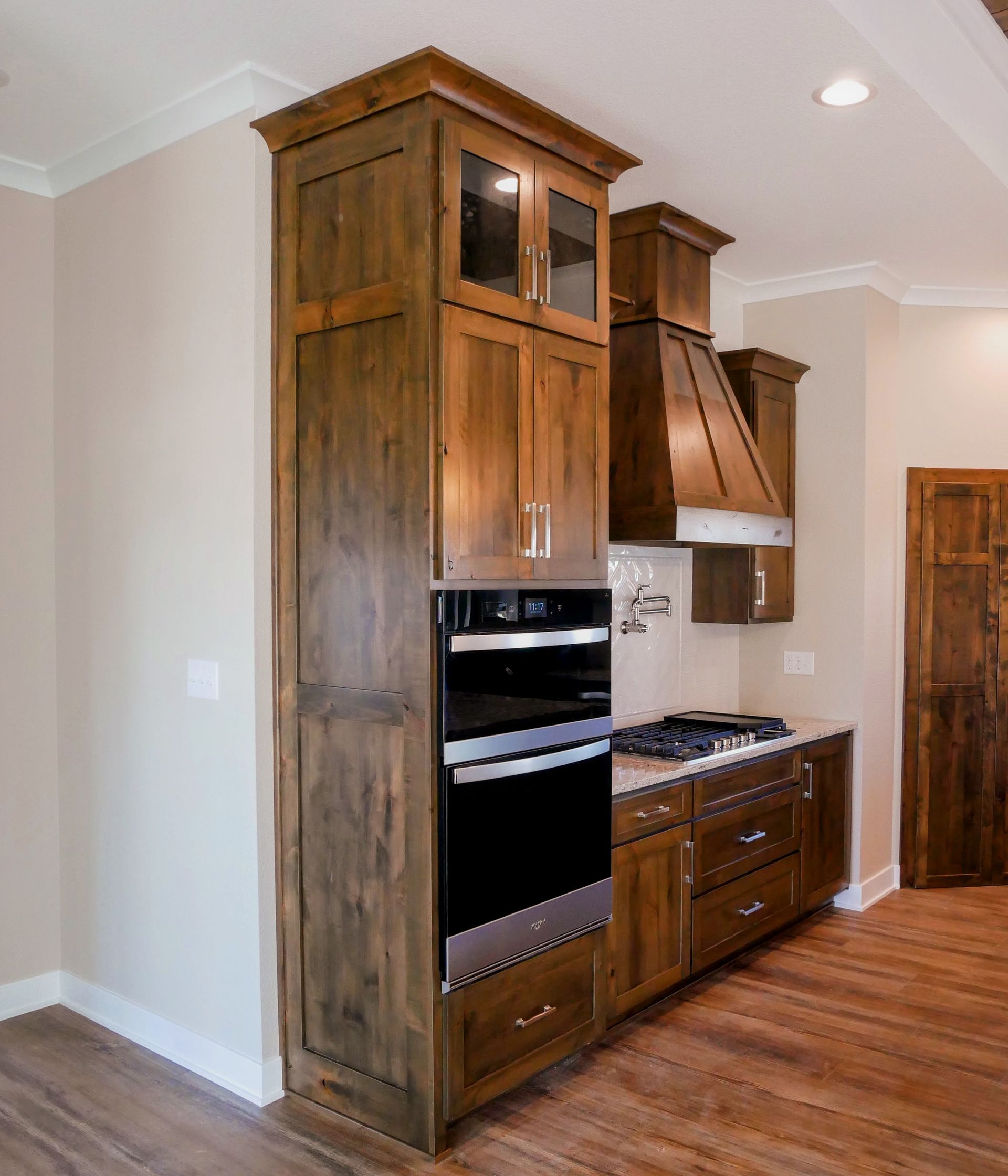 A kitchen with wooden cabinets and stainless steel appliances