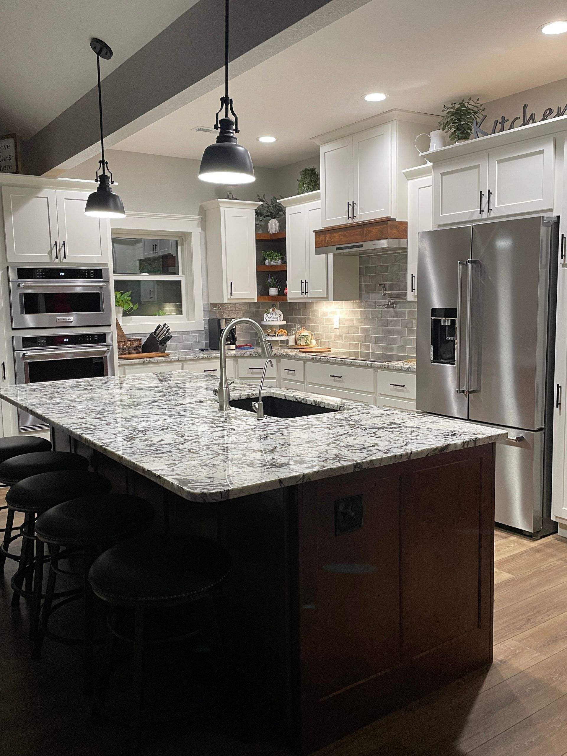 A kitchen with granite counter tops and stainless steel appliances