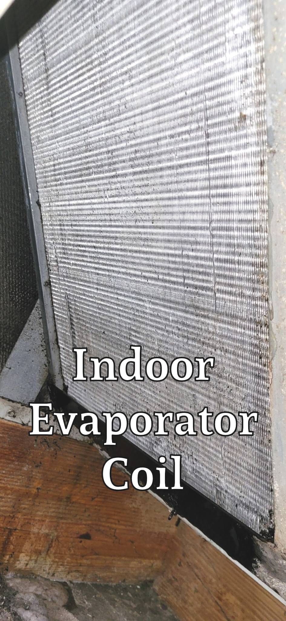 A close up of an indoor evaporator coil on a wall.