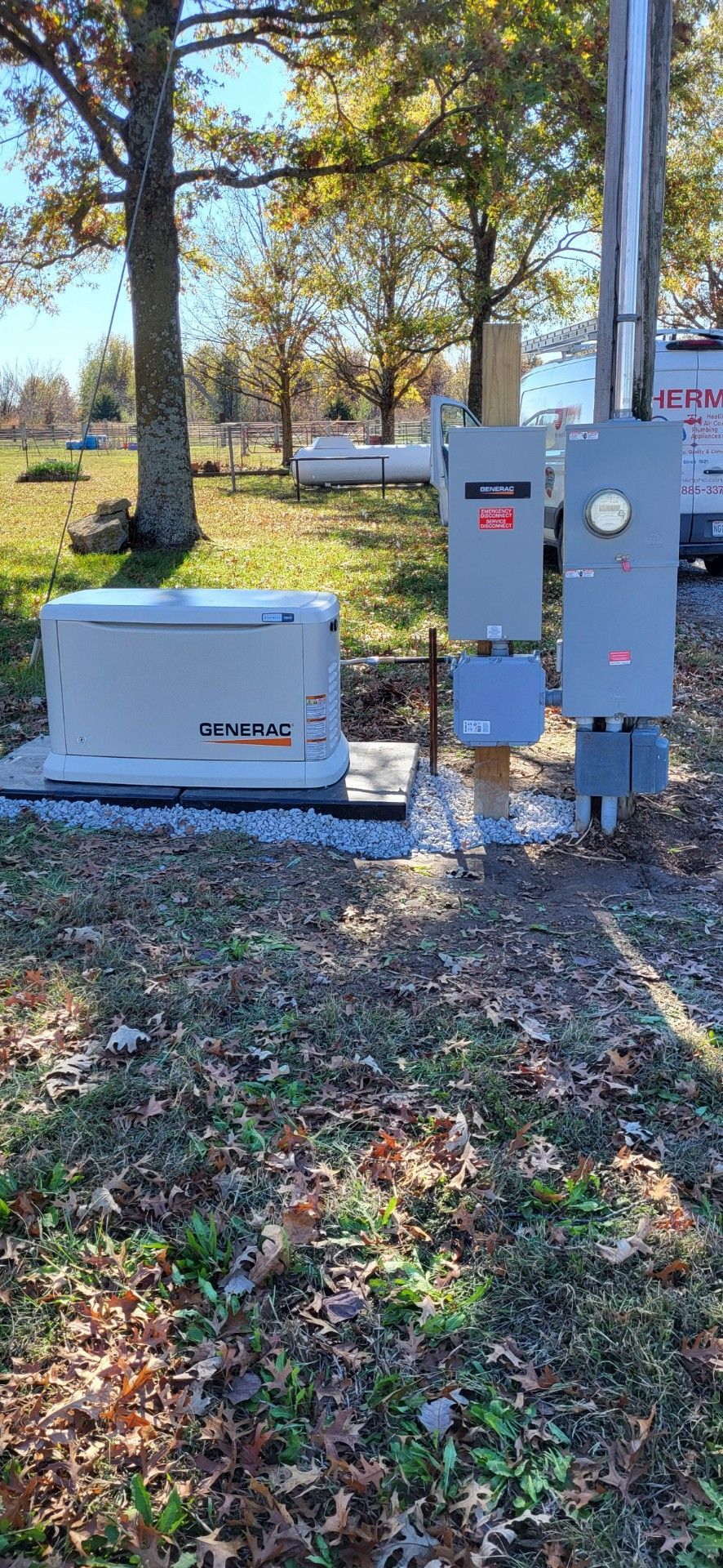 A Generac generator with electrical panels in an outdoor setting.