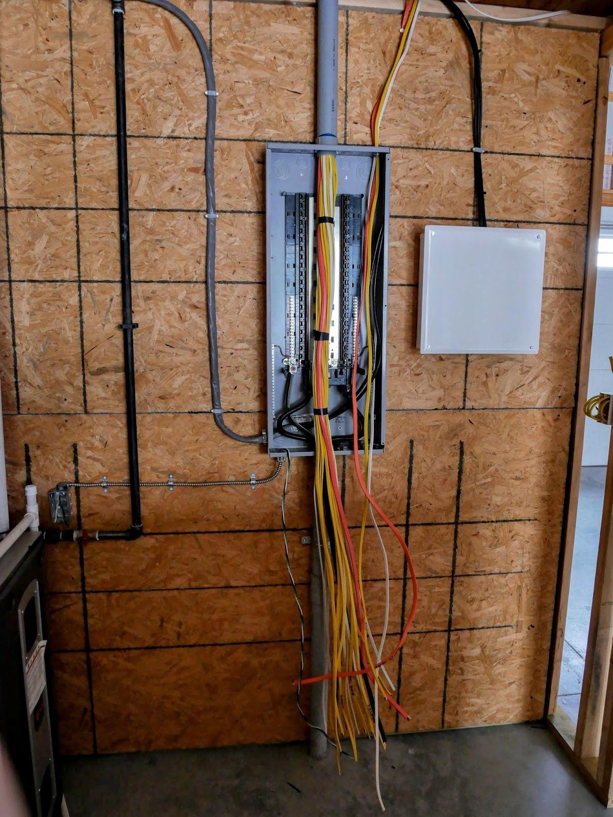A wall with a bunch of wires hanging from it