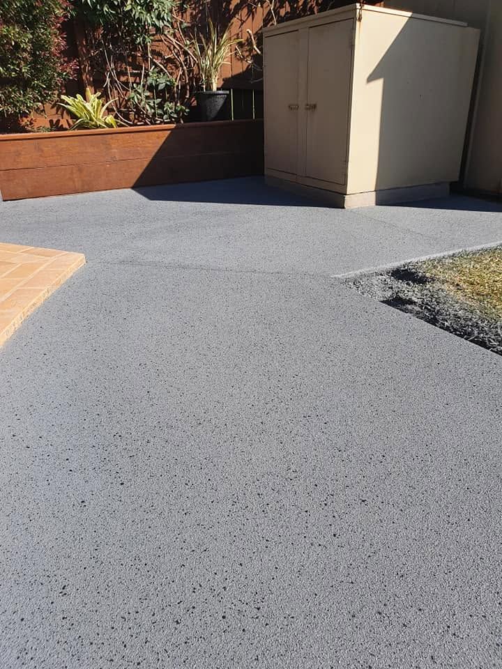 Outdoor Patio with Gray Textured Paving, a Beige Storage Cabinet — Mid North Coast Spray Pave in Wauchope, NSW