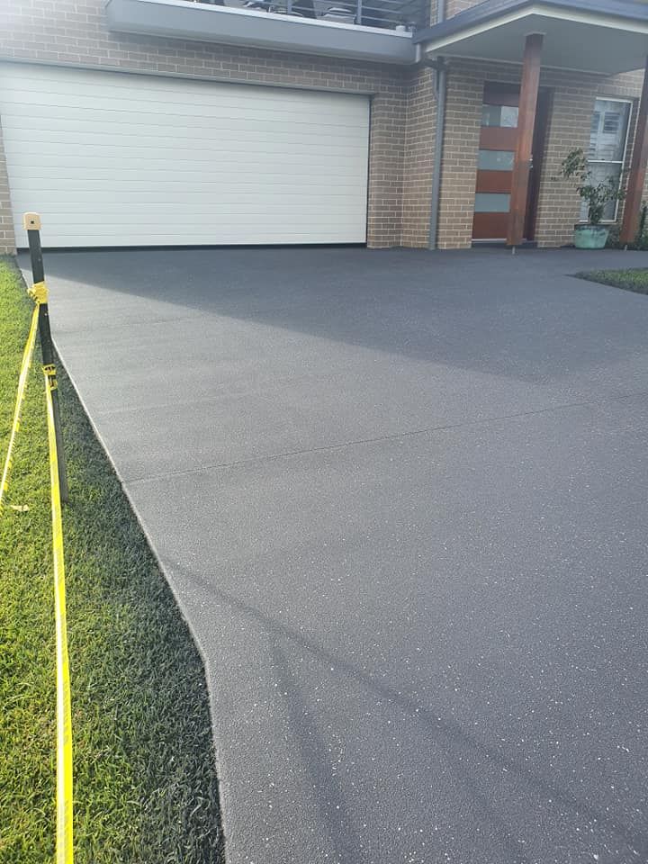 A Driveway Leading To A House With A Garage Door — Mid North Coast Spray Pave in Port Macquarie, NSW