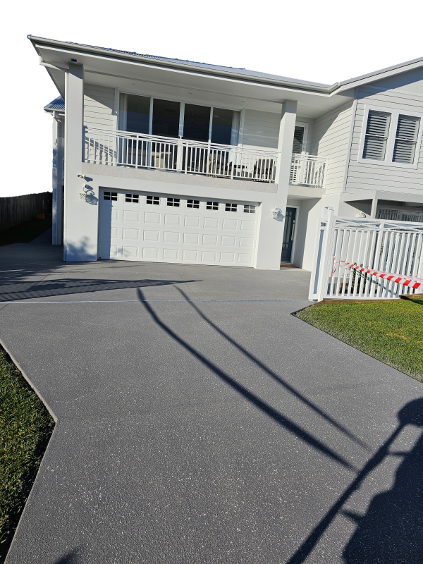 A Large White House With a Driveway Leading to It — Mid North Coast Spray Pave in Port Macquarie, NSW