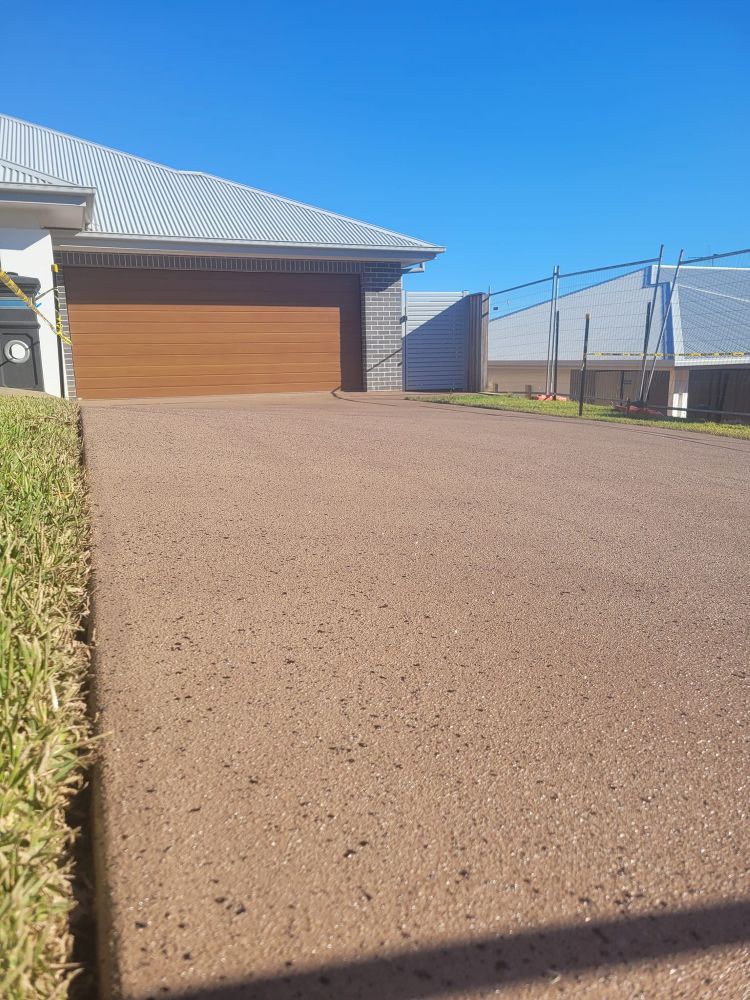 A Driveway Leading to a House With a Garage Door — Mid North Coast Spray Pave in Mid North Coast, NSW