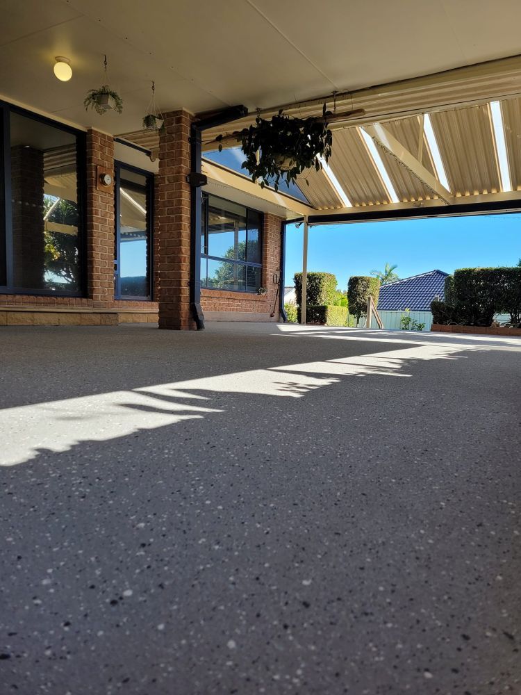 A Brick Building With a Covered Porch and a Roof — Mid North Coast Spray Pave in Port Macquarie, NSW