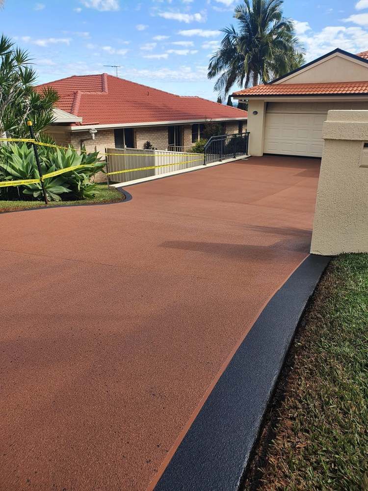 A Driveway Leading to a House With a Red Roof — Mid North Coast Spray Pave in Mid North Coast, NSW
