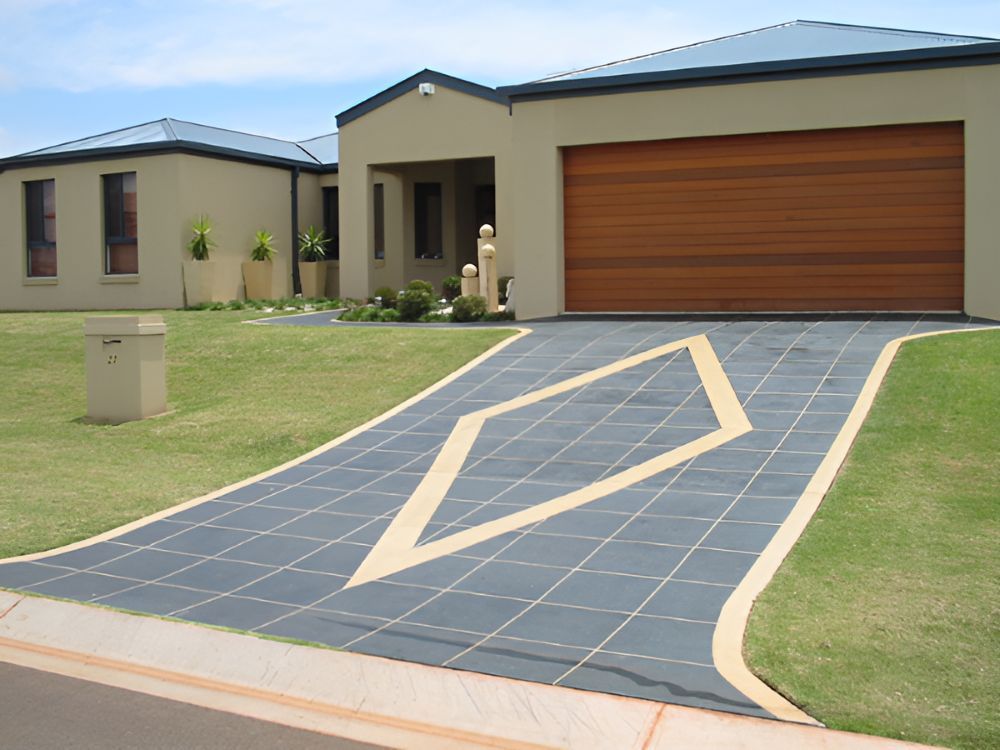 A Driveway Leading to a House With a Wooden Garage Door — Mid North Coast Spray Pave in Port Macquarie, NSW