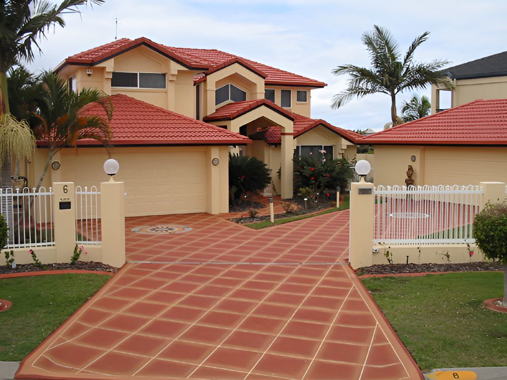 A Large House With a Red Tiled Roof and a Driveway — Mid North Coast Spray Pave in Port Macquarie, NSW