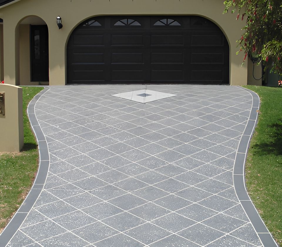 A Driveway Leading to a House With a Black Garage Door — Mid North Coast Spray Pave in Port Macquarie, NSW