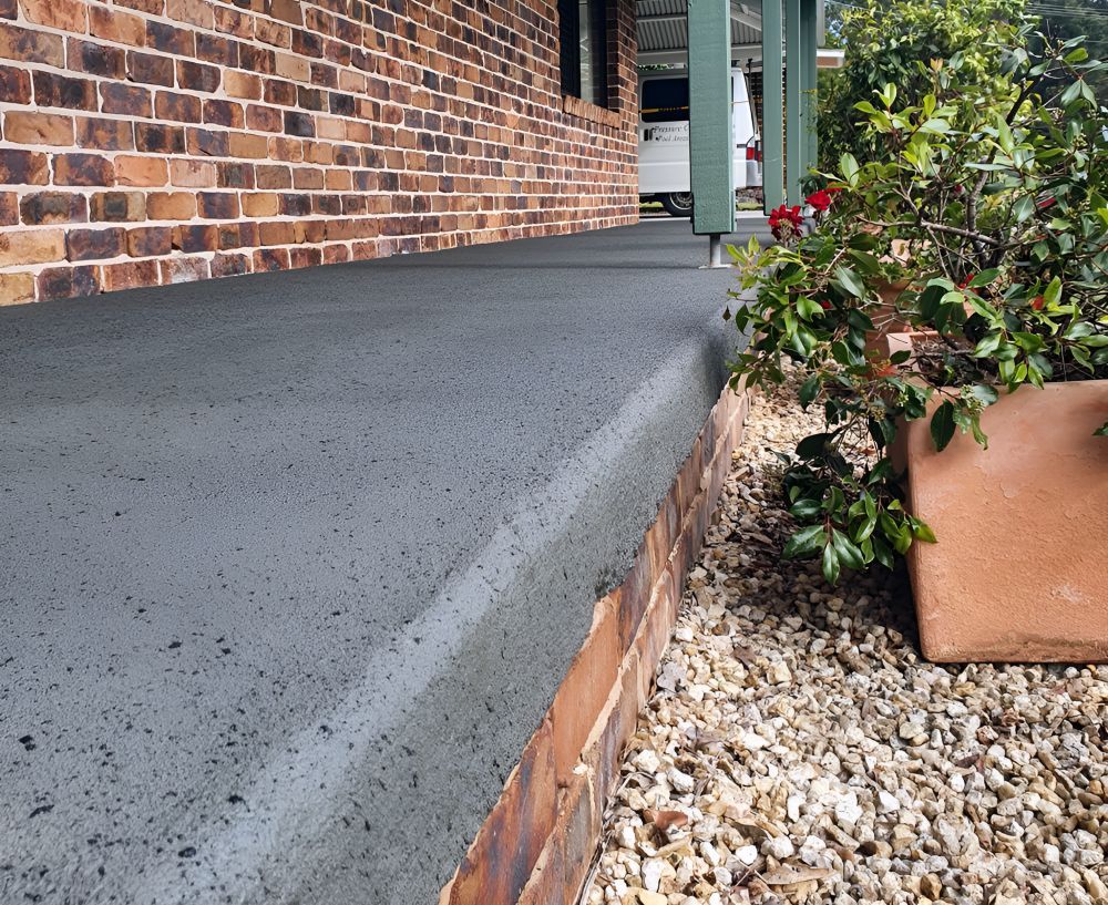 A Brick House With a Concrete Porch and Steps — Mid North Coast Spray Pave in Port Macquarie, NSW