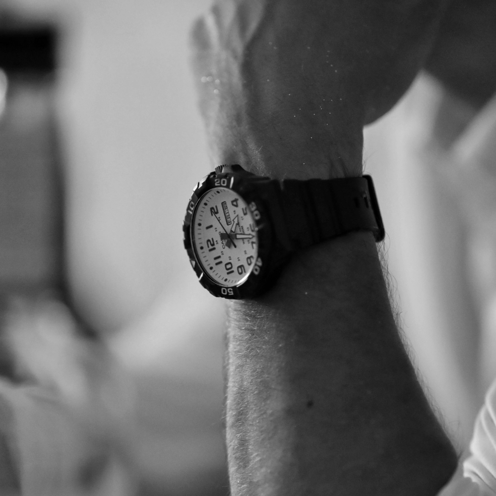 Black watch with silver case and black leather strap.
