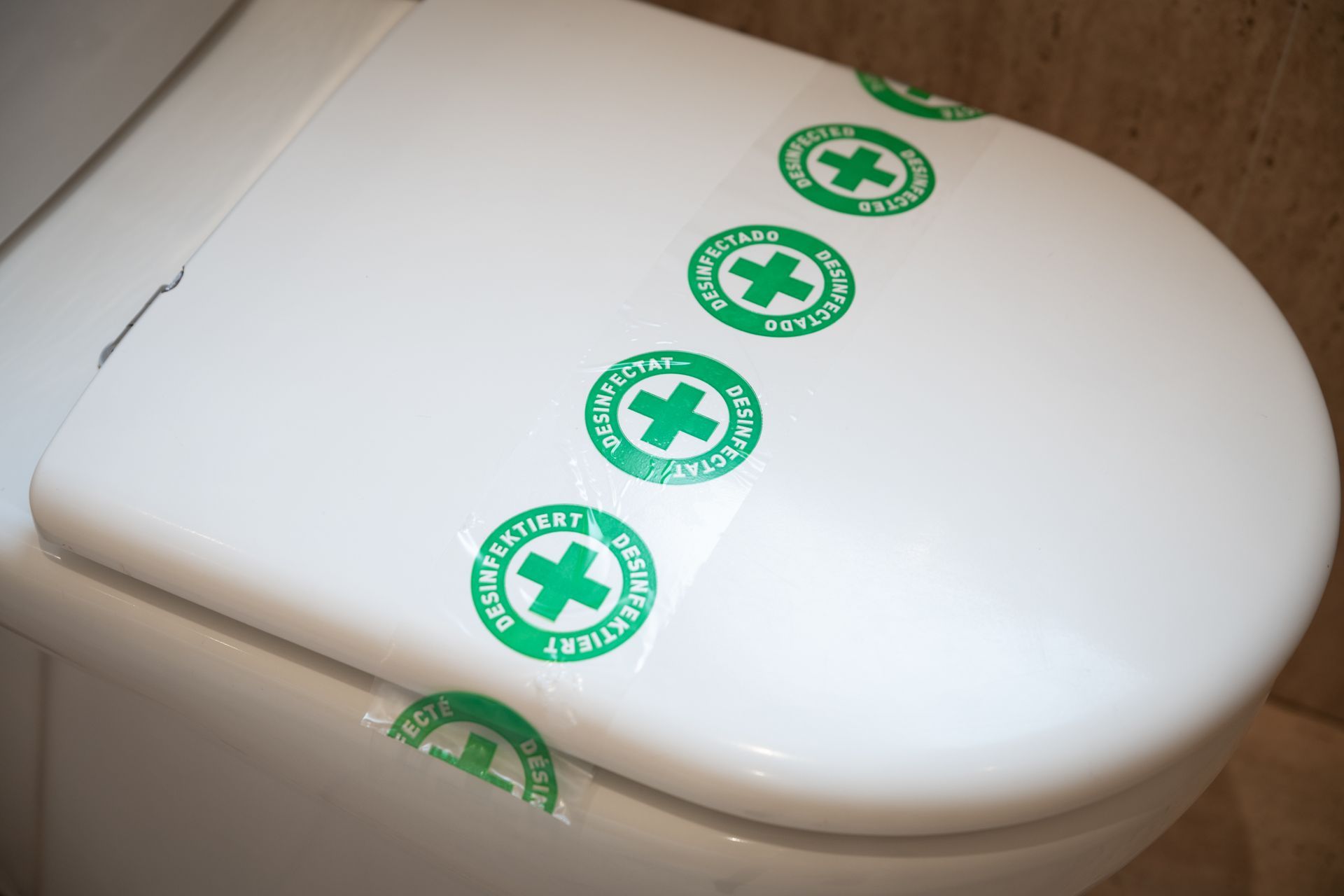 Tapa blanca del inodoro con adhesivos verdes de estilo médico en la parte superior