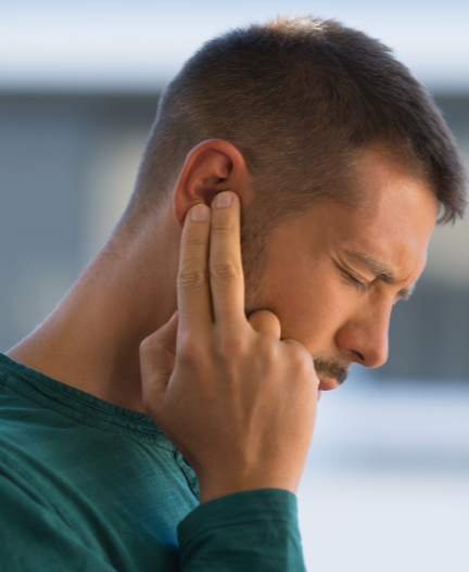 Tinnitus Management with The Hearing Boutique- Man holding ear in pain.