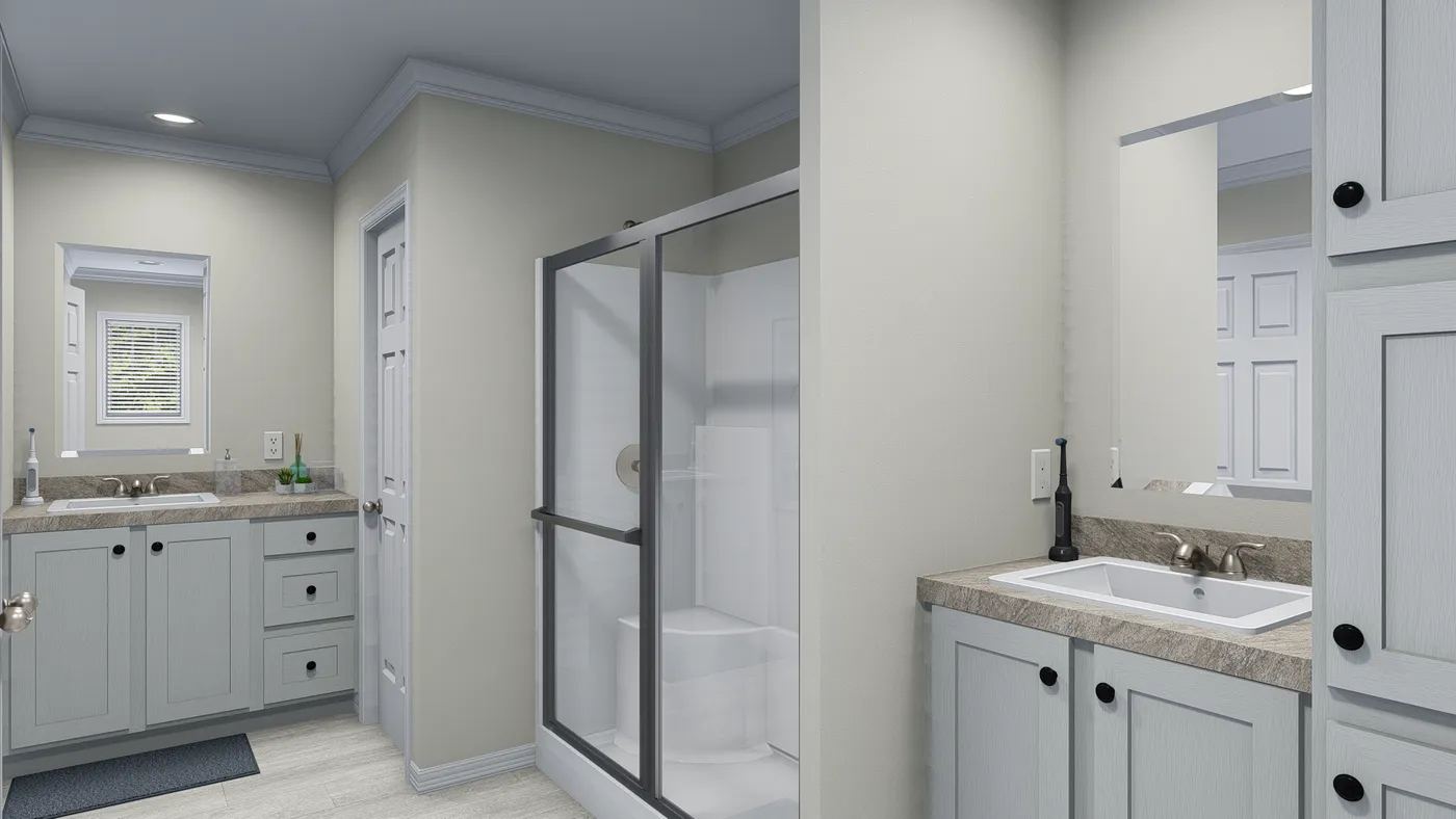 Bathroom with two vanities, shower, and closed door. Gray cabinets and neutral walls.